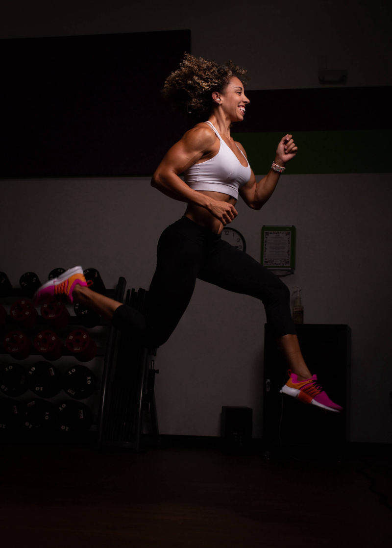 Athlete mid-leap showing energetic workout form